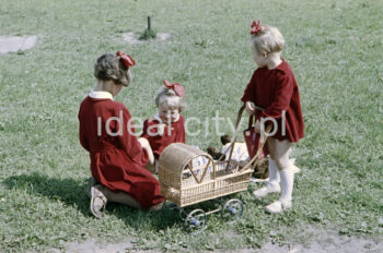 Little girls with a doll pram. Color photograph, 1950., Nowa Huta.

Photo by Wiktor Pental/idealcity.pl
