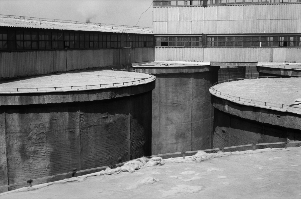A view from above on the covers of huge tanks built side by side.