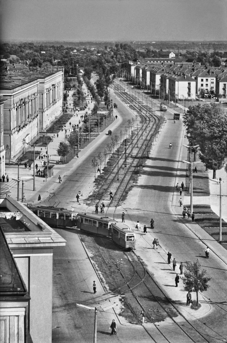 A view from above on a wide avenue with a tram track in the middle.
