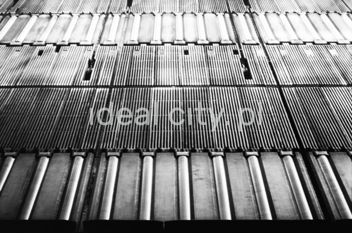 Top view of successive rows of metal transport rollers.