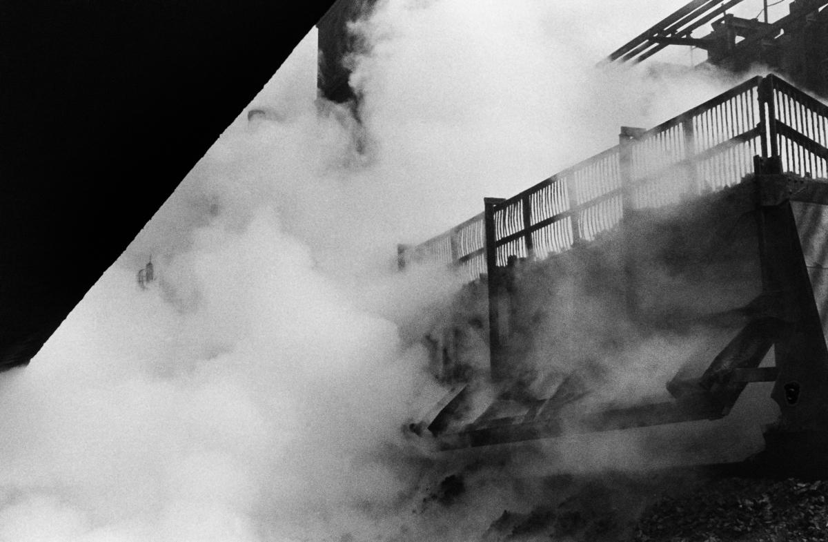 Intake for a smoking coke heap located between the constructions of the plant.