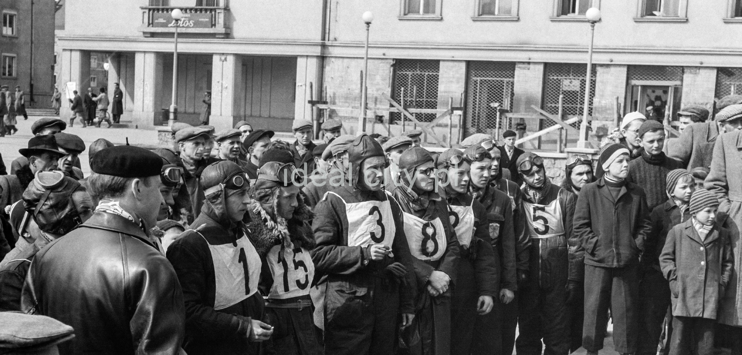 A group of riders wearing motorcycle clothing awaits the guidelines of the rally organizers.