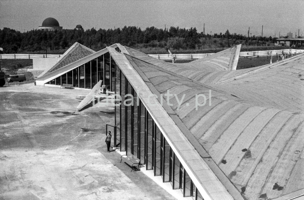View from above on glass, modernist pavilions with sloping roofs.