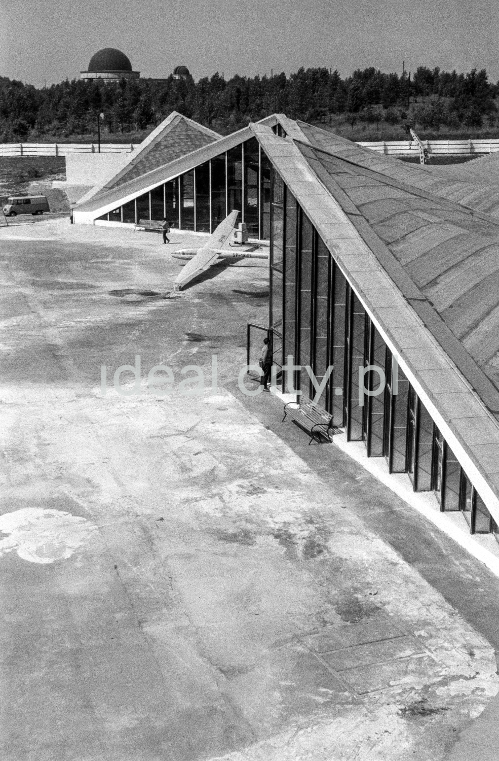 View from above on glass, modernist pavilions with sloping roofs.