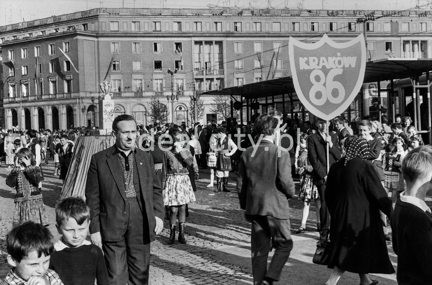 A view of the wide street during one of the celebrations, with modernist apartment blocks in the background.