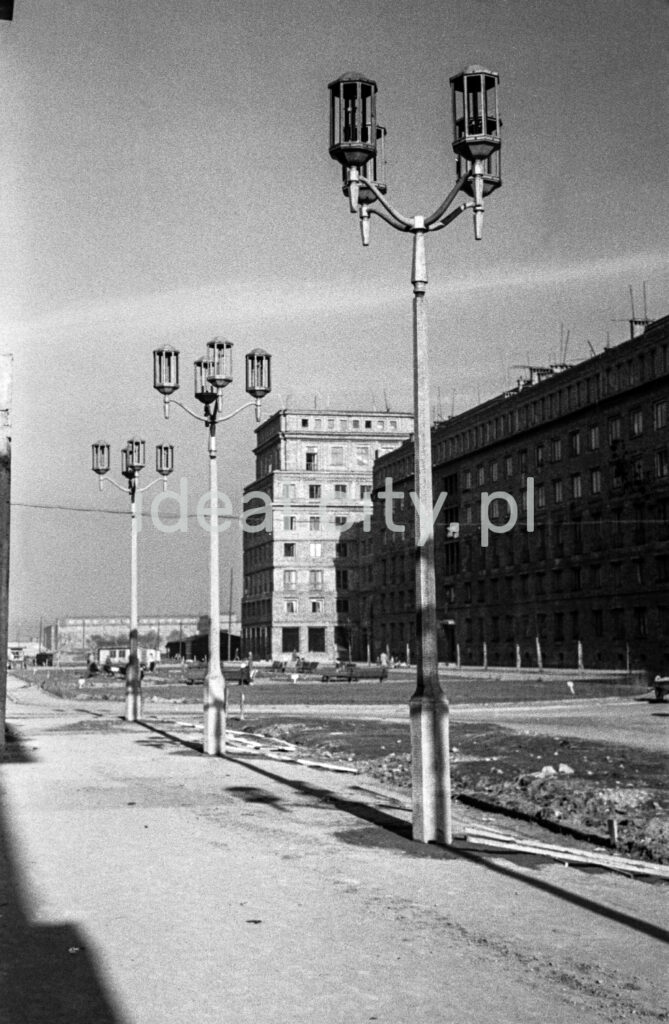 Monumental lanterns in the middle of an unfinished spatial square between socialist realist tenement houses.