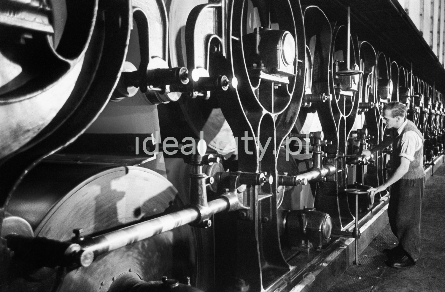 The man is regulating a powerful machine.