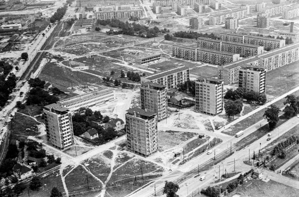 An aerial view of a modernist housing estate with skyscrapers in the foreground.