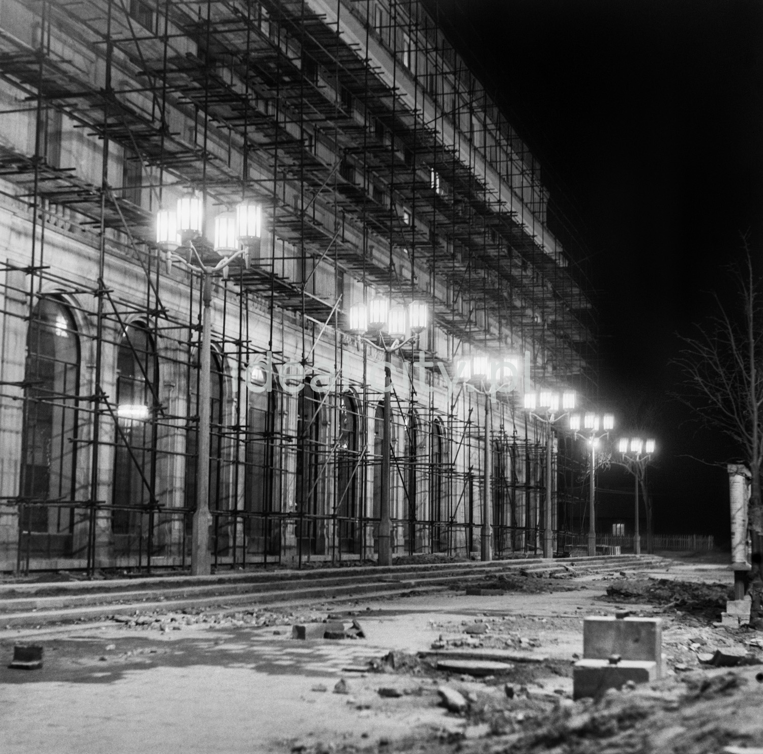 Monumental residential building tucked behind scaffolding.