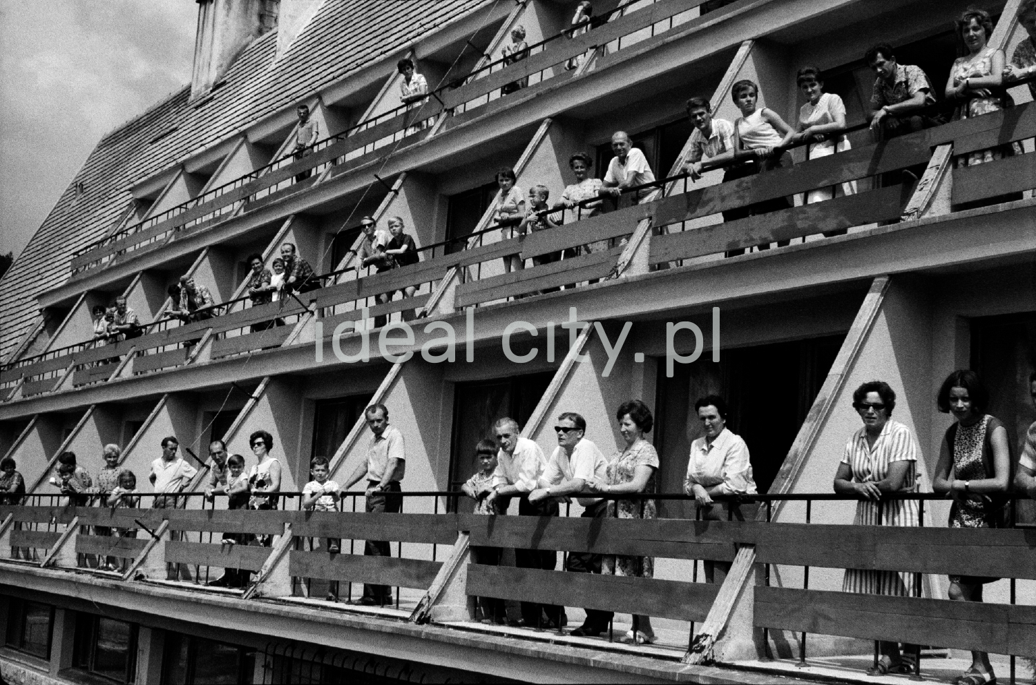 Holidaymakers on the balconies of the holiday home.