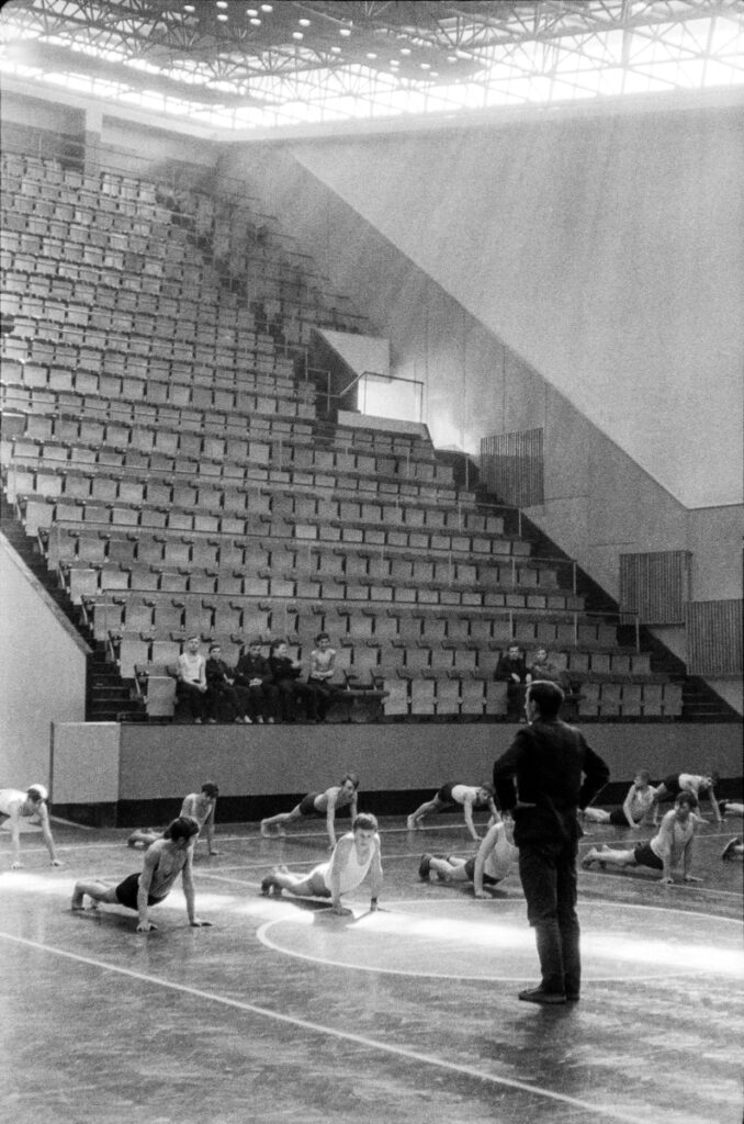 Young people during exercises in a sports hall.