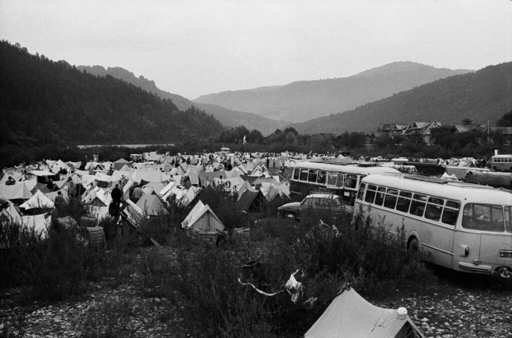 Tents fill the green valley to the horizon.