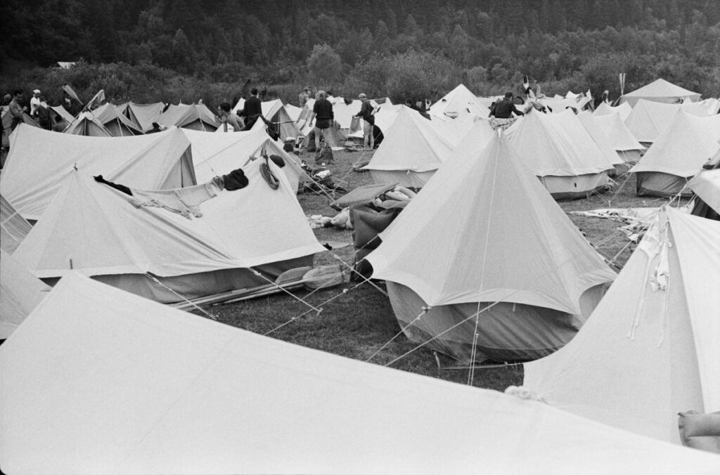 Tents fill the green valley to the horizon.