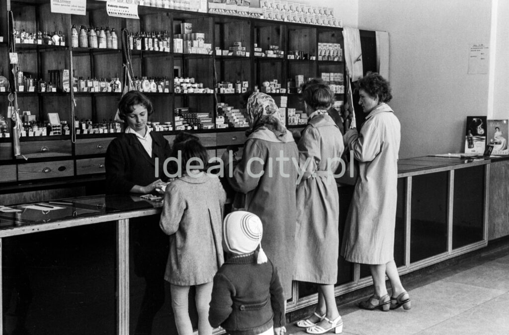 Several women in coats are standing at the counter of a cosmetics stand